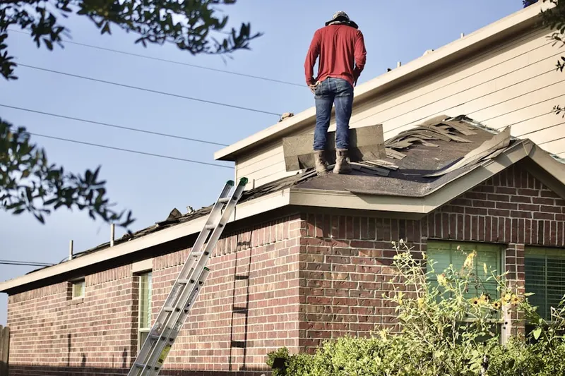 Professional roofer working on a residential roof in Enders